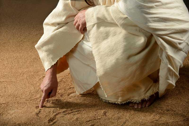 Man writing in sand